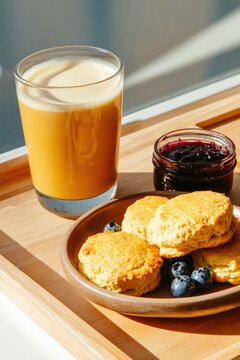 Delicious breakfast scene with biscuits, blueberries, and refres