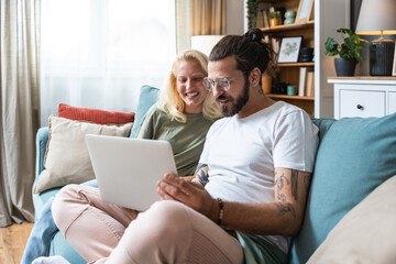Simple living. Young couple, man and woman, leisure activity at home. Two relaxed people in love, enjoying their life. Love and respect between male and female engaged persons in modern cozy apartment