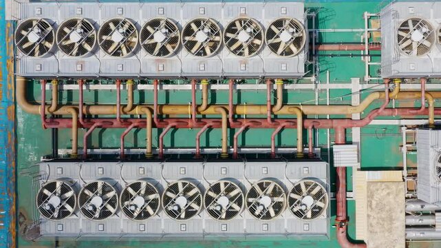 4K aerial view of an industrial rooftop showcasing a complex network of HVAC systems. Perfect for illustrating infrastructure, technology, and urban development in crisp.