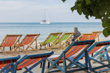 Thailand. Koh Chang. Beach chairs by the sea.