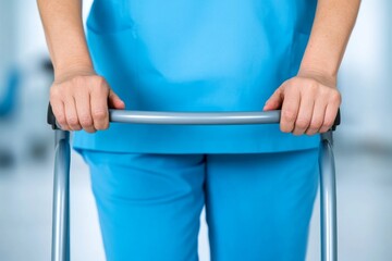 A nurse assisting a patient to walk again after surgery using a walker