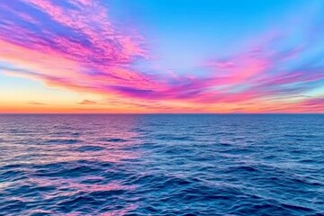 Obraz premium A peaceful coastal sunset with the sky turning shades of pink and orange as waves gently roll in