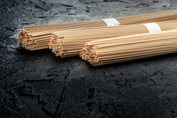 Soba, Japanese buckwheat noodles, on a black background, with copy space