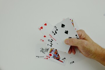 Poker cards scattered on the table and in my hand.