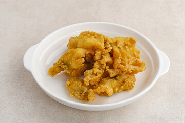 Fillet Ikan Telur Asin. Crispy fried fish fillet covered with salted egg sauce. Indonesian food
