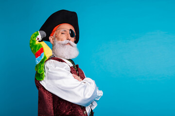 Photo portrait of old funny pirate male crossed hands confident dressed carnival party costume party isolated blue color background