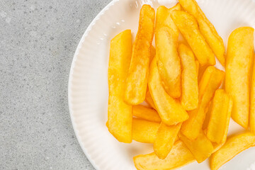 crispy golden French fries. homemade roasted potatoes in the air fryer. top view. copy space