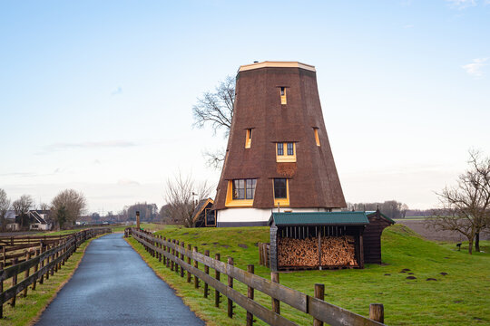 Truncated traditional Dutch windmill along the river Rotte in Moerkapelle, Netherlands