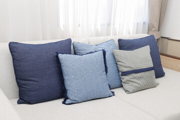 Cozy decorative pillows on sofa in living room home decor indoor relaxed atmosphere