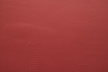 Textured red wall surface in indoor space minimalist design close-up view