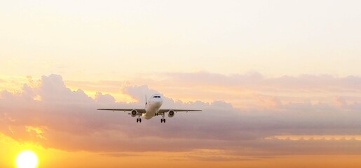ULTRA HD. Airplane flies in sunset sky. Travel. Airplane takes off against the background of sunset sky.	

