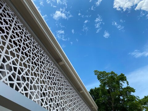 Islamic, Muslim building featuring modern Arabesque design. pattern inspired by ancient Arabian Middle Eastern civilization, culture and religion. blue sky and copy space