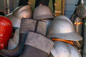 old antique firefighting equipment. classic antique fire brigade equipment. old helmets, galoshes.