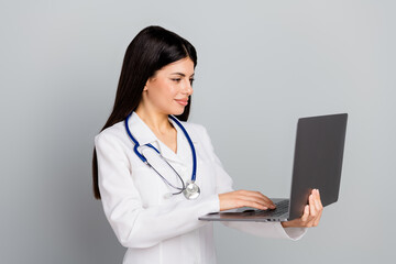 Professional doctor in medical uniform using a laptop for healthcare work