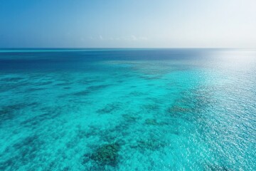 Fototapeta premium Endless turquoise waters blend seamlessly with clear blue sky, c