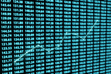 Naklejka premium Blue glowing line graph in front of a wall of defocused stock figures. Illustration as the concept of profitable investment and rising business revenue