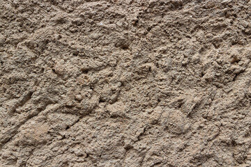 Background of grey rough uneven cement plaster with grainy sand texture