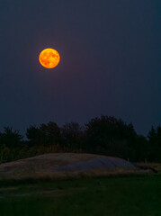 full moon, red full moon over the village.