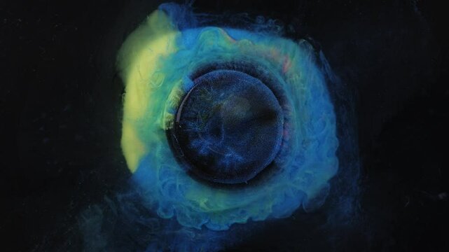 Abstract liquid art featuring a centered black circle surrounded by vivid neon hues of yellow, pink, and blue. Ideal for inserting logos, text overlays, or digital designs.