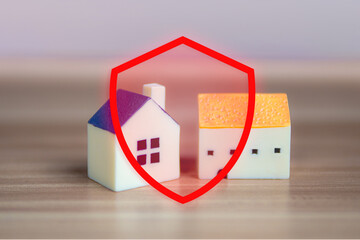 Houses under a protective red shield. concepts of home insurance, property protection, and marketing materials related to insurance, real estate, and financial services.