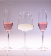 White and pink wine in glasses for tasting with friends. light background