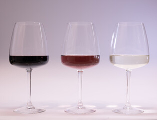 Red, white and rose wine glasses up. White background