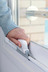 man cleaning a white aluminum sliding window