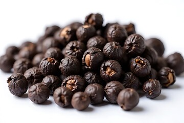 Obraz premium mound of dark brown fruits or seeds sits on a plain surface.