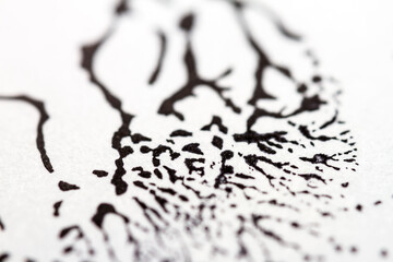 Extreme close up of black acrylic paint texture on paper. Selective focus.