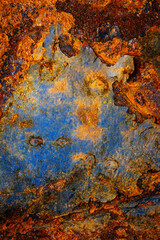 Rusty metal surface with shabby background paint. Blue cracked paint texture on an iron sheet. Fragment of an old metal door, Metal corrosion.
