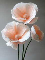 Three beautifully arranged flowers in a simple elegant vase showcasing their unique colors and textures