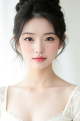 Female Asian Model with Short Hair - Young Beautiful Woman with Hair Bun - Studio Portrait of Asian Beauty for Fashion, Cosmetic, Skincare - Posing on White Background - Smooth Tied Hair