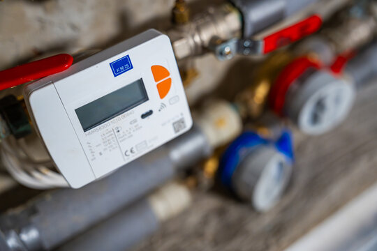 Smart water and heat meters with remote data transmission installed in a European utility system. The concept represents modern energy efficiency and digital infrastructure development