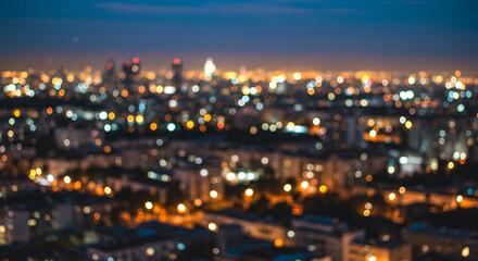 "A cityscape with a soft bokeh effect created by out-of-focus lights, giving a dreamy and atmospheric urban night scene."
