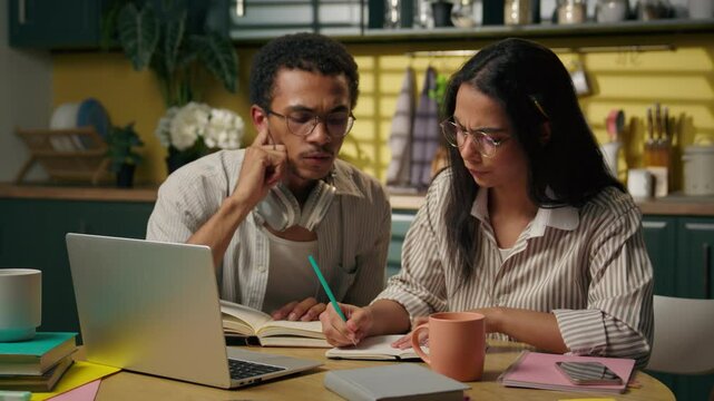 African American man Latina woman girl guy high school students business freelancers multiracial teens distant studying together at home kitchen university laptop computer write homework online class