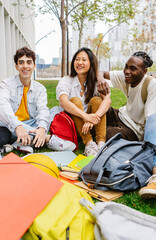 Vertical shot of diverse group of young teenage students relaxing at high school campus. Youth and education lifestyle concept