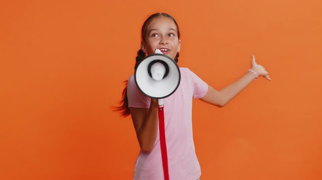 Young preteen child girl kid talking with megaphone proclaiming news, loudly announcing advertisement discounts sale, using loudspeaker to shout speech. Teenager children isolated on orange background