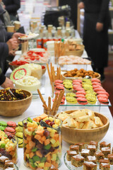 catering buffet with variety of food snacks and appetizers.