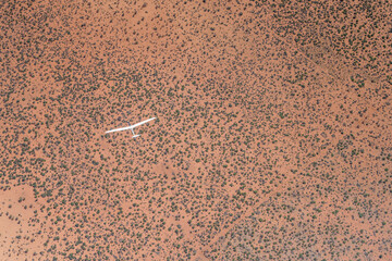 glider in flight above red Kalahari desert countryside, near Praia de Miragem, Namibia