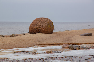 Lauci big stone (Laucakmens) at the Baltic sea in late winter in February on a cloudy day in Latvia