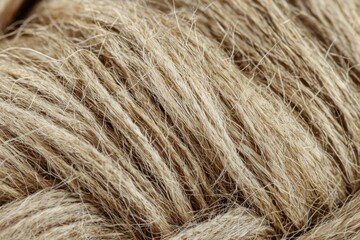 Detailed close-up of natural jute rope, showcasing its rough texture and intertwined fibers, ideal for rustic or nautical themed designs and backgrounds.