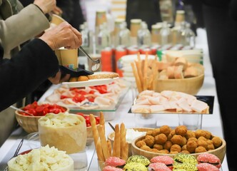catering buffet with variety of food snacks and appetizers.