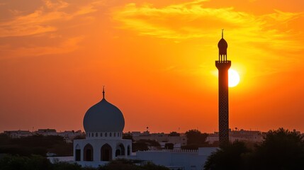 Fototapeta premium Mosque Silhouette at Sunset with Vibrant Orange Sky and Minaret Tower