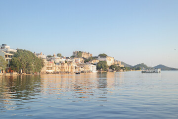 Fototapeta premium The City Palace by lake Pichola in Udaipur, the city of lakes in the Province of Rajasthan, India.