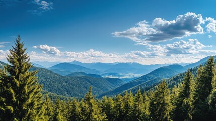 Fototapeta premium Breathtaking panoramic view of green mountains and valleys under a clear blue sky with scattered clouds during the day