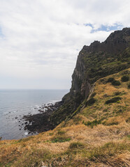 Jeju-do, Seongsan Ilchulbong  landscape, volcanic tuff cone, Sunrise peak, Jeju Island, South Korea, Seongsan-ri, Seogwipo, Jeju Province landscape view in a sunny day, with sea, cliffs hiking trail