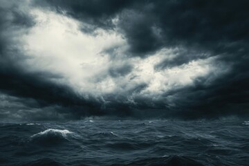 Fototapeta premium Dark storm clouds over a turbulent ocean with crashing waves, creating a dramatic and ominous atmosphere of nature’s power