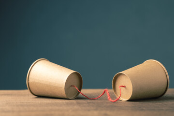 Paer cup phone with rope, old style communication, two-way communication concept