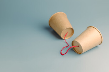 Paer cup phone with rope, old style communication, two-way communication concept