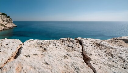 Soft weathered limestone slab for product placement and advertisement near a Mediterranean coastline, with turquoise waters in the background